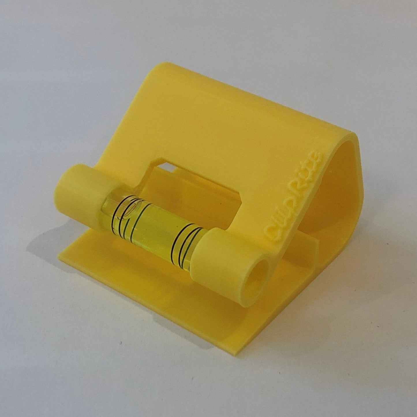 "Yellow hands-free plastic clip-on level, designed for easy attachment to surfaces, featuring a built-in bubble vial for precise alignment during leveling tasks."